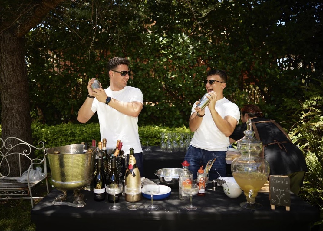 Boys mixing cocktails at a garden event
